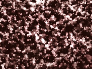 Close up of dark background covered in white and pink glitter
