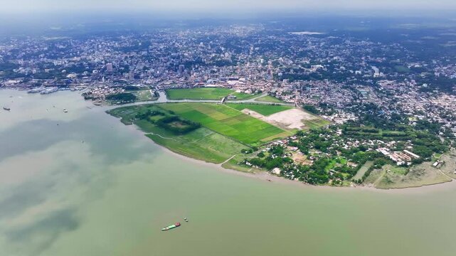 Dynamic Aerial Footage Highlighting Riverboats, Piers, and Urban Development