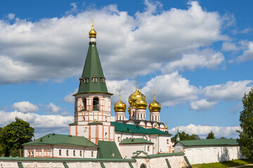 Valday Iversky Monastery, Valday (Valdai), Novgorod region, Russia. View of the monastery wall, bell tower and golden domes of the Cathedral of the Iveron Icon of the Mother of God. Travel in Russia.
