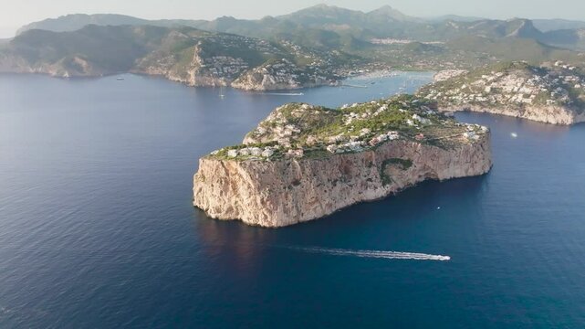 Aerial view of small scattered limestone islands and boat in water, Mallorca