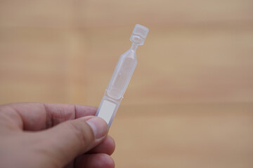 Tube of single use artificial tear lubricant eye drops. Concept, medical products for dry eyes or...