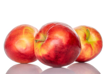 Three red apples, macro, isolated on white background.