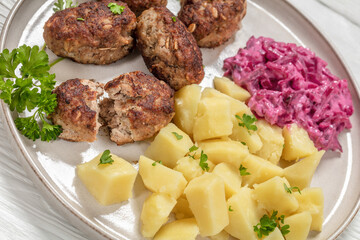 frikadeller, danish meatballs on a plate, top view