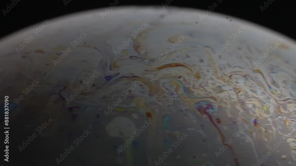 Poster abstract view of multicolored surface of sci-fi planet. soap bubble ball on black background. macro.