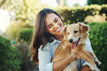 Outdoor, woman and smile for dog hug with bonding time, loyalty and best friends together in...