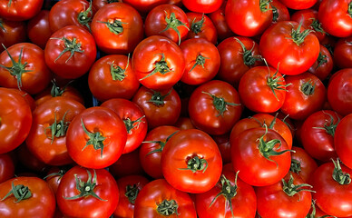 Red tomatoes on market table close-up, top view. Vitamin healthy food image. Fresh organic vegetables and tomatoes, Vegan raw food. Clean eating concept. 