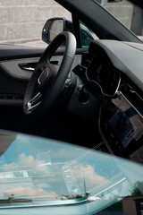 View of the interior of the first row of the car from the street through the passenger window