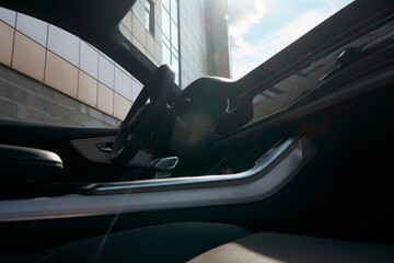 View of the interior of the first row of the car from the street through the passenger window