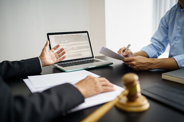Lawyer Legal counsel presents to the client a signed contract with gavel and legal law. justice and lawyer Business partnership meeting concept.