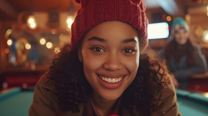 A young, diverse group of people, smiling and laughing, play pool together and enjoy their time