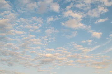 Beautiful clearly deep blue sky with white a little puffy clouds in a sunny day, soft focus.