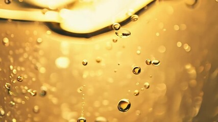 Champagne golden bubbles flowing. macro champagne bubbles texture on soft gold background. 4k video Celebrate background - Powered by Adobe