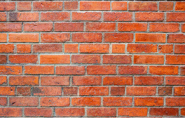 Red brick wall with a textured surface, perfect as a background