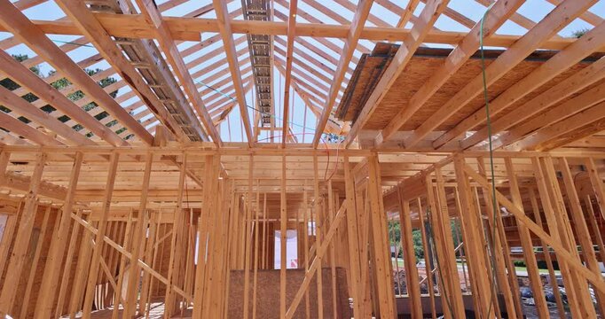 Roof of new timber truss framed home is in process of being installed