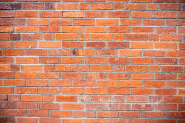Red brick wall with a textured surface, perfect as a background