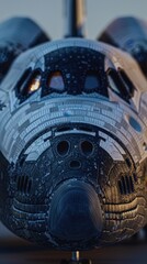 Front view of a space shuttle cockpit showing detailed exterior surface with windows and intricate textures, ready for space travel.