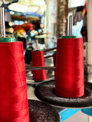 Babies of red thread for a sewing machine in close-up