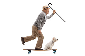 Full length profile shot of a senior man with a dog riding a longboard