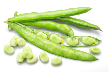 Green broad bean pod and several broad beans isolated on white background.