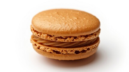 Macro shot of a delicious French caramel macaroon, isolated on a white background. Sweet and flavorful dessert close-up view