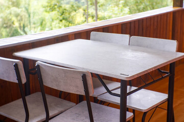View of wooden table and wooden chairs in the villa
