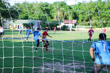 A soccer goal net is visible in the afternoon