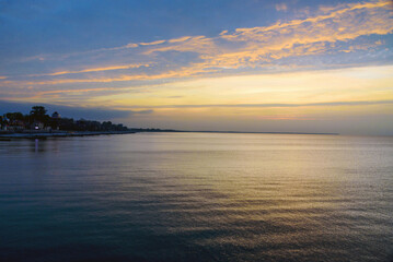 Fototapeta premium View of sand beach with wooden breakwaters on the Baltic Sea coast on sunset in Zelenogradsk. Russia