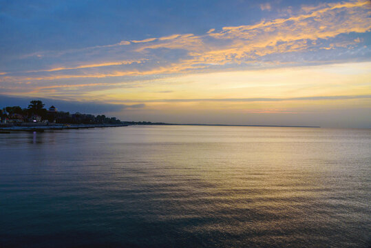 View of sand beach with wooden breakwaters on the Baltic Sea coast on sunset in Zelenogradsk. Russia - Powered by Adobe