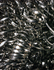 Macro twisted spiral stainless steel  shavings background, metal sponge close up stainless steel scrap materials recycling, macro