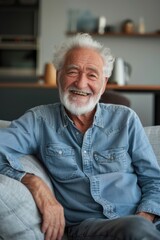 A happy person sitting on a couch, perfect for showcasing relaxation and leisure