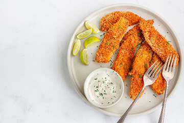 Air Fryer Fish with Lemon Wedges, Condiment and Fresh Dill Top Down Photo