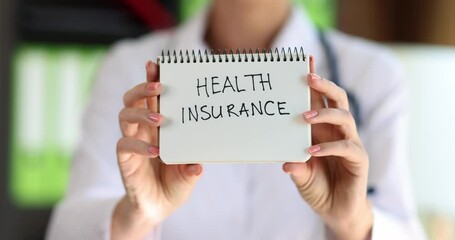 Therapist doctor shows notebook with words health insurance. Health worker recommends taking out health insurance