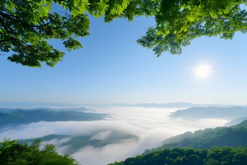 Beautiful mountain landscape with low clouds and morning sun shining through a clear blue sky.