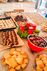 Cookies Biscuites and Macroons Coated and Baked on the Kitchen Table Top for Christmas with an Advent Wreath