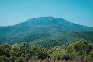Fototapeta premium Picturesque mountain landscape with lush green hills and blue sky