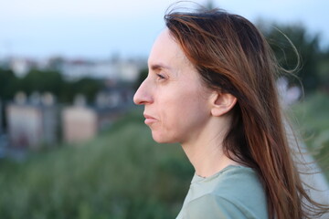 evening outdoor photo of a woman looking into the distance on a hill in the Lower Town of Gdańsk