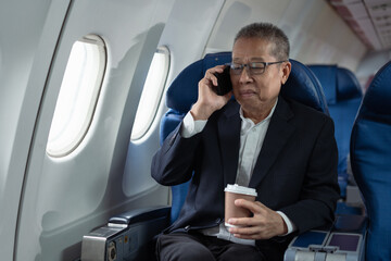 Airplane, travel and portrait of businessman working on laptop computer and smartphone while sitting in airplane.