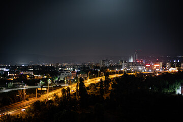 Night view of the city of Sofia with glowing lights of the cars speeding on a highway