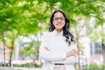 Portrait Indian business women female happy smile. Young Asian success businesswomen happy at green city office park outdoors.