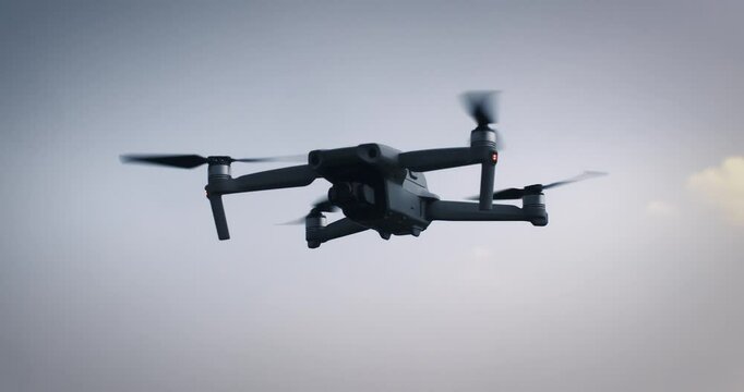 Super slow motion of latest technology high tech drone is flying  against blue sky at 1000 fps.