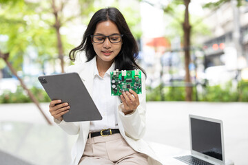 Fototapeta premium Business women computer hardware engineer. Project lead PCB designer looking at sample circuit board ready to mass production.