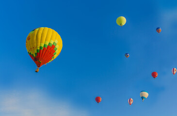 Colorful balloons are flying in the blue sky