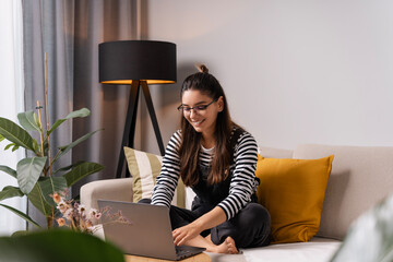 Bringing the study session home. A modern student hitting the books and her laptop, making study...
