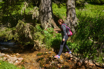 Fototapeta premium Woman hiker on a trail in the mountains