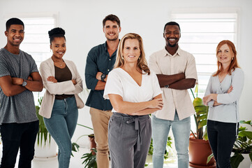 Business team, portrait and arms crossed in office with leadership, company pride and happy group for startup. Design staff, collaboration and employees with diversity, creative agency and solidarity