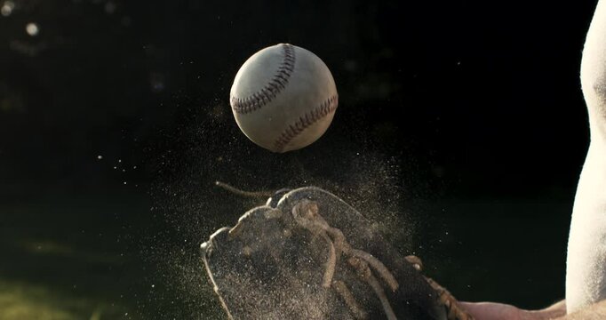 Super slow motion close up of baseball player practice with ball during workout before competition game match on baseball stadium on sunset at 1000 fps.