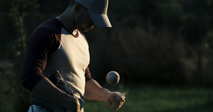 Super slow motion of baseball player practice with ball during workout before competition game match on baseball stadium on sunset at 1000 fps.