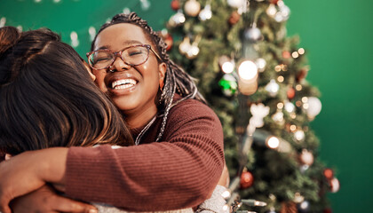 Friends, hug and Christmas tree for festive, holiday and celebration as happy woman in home. Female people, together and bonding with embrace, excited and solidarity for relationship in December