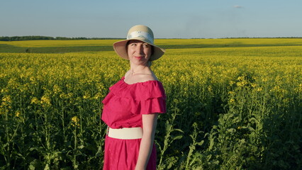 Happy Female. Woman With Bouquet Of Flowers In Field. Pink Dress With A Bouquet Of Yellow Flowers...