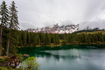 Cloudy sky over Lake Carezza in South Tyrol, Italy.